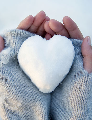 hands holding snow heart